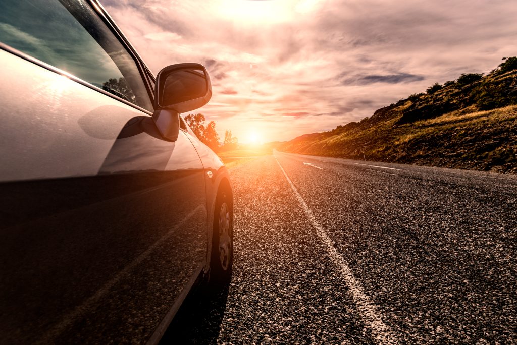 Películas Automotivas e Conforto Térmico: Viaje com Elegância e Frescor viajar de carro por uma estrada ensolarada